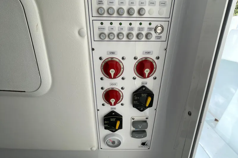  Yacht Photos Pics Control panel of a 2023 Contender 30 Tournament boat with switches and dials.