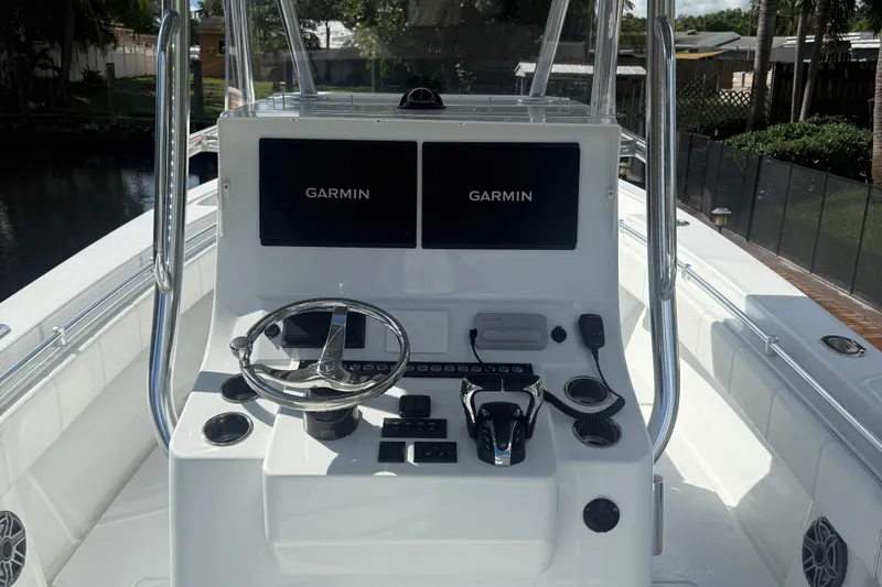  Yacht Photos Pics 2023 Contender 30 Tournament boat dashboard with dual Garmin displays and steering wheel.