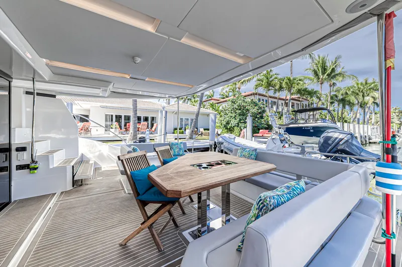 Double Feature Yacht Photos Pics 2023 Leopard 53 Powercat yacht with elegant outdoor seating and dining area.