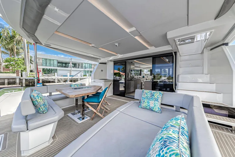 Double Feature Yacht Photos Pics Luxurious 2023 Leopard 53 Powercat yacht interior with modern seating and vibrant cushions.