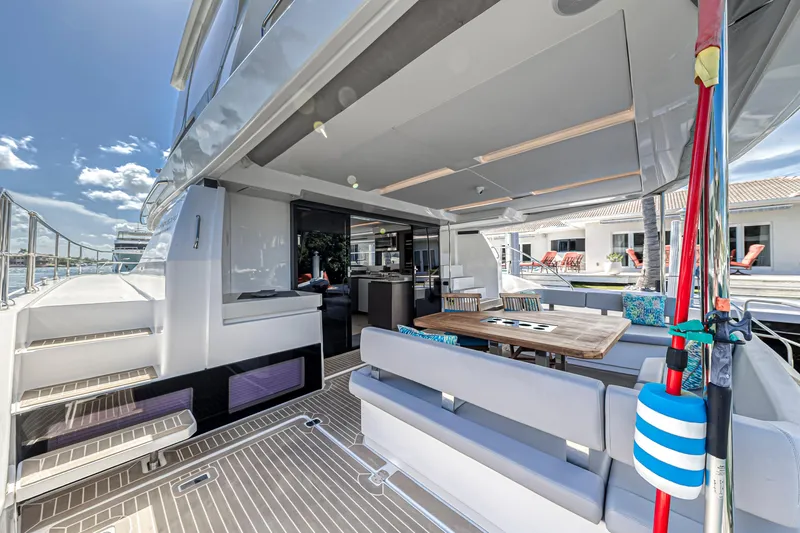 Double Feature Yacht Photos Pics 2023 Leopard 53 Powercat yacht with spacious outdoor seating and dining area.