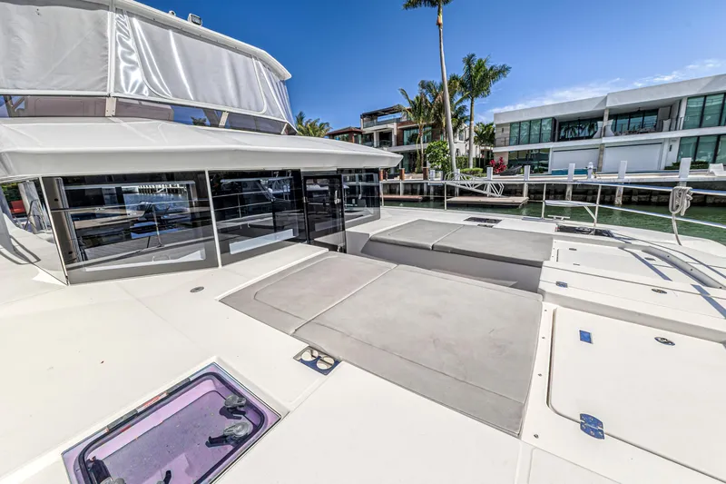 Double Feature Yacht Photos Pics 2023 Leopard 53 Powercat yacht deck with modern design and waterfront view.