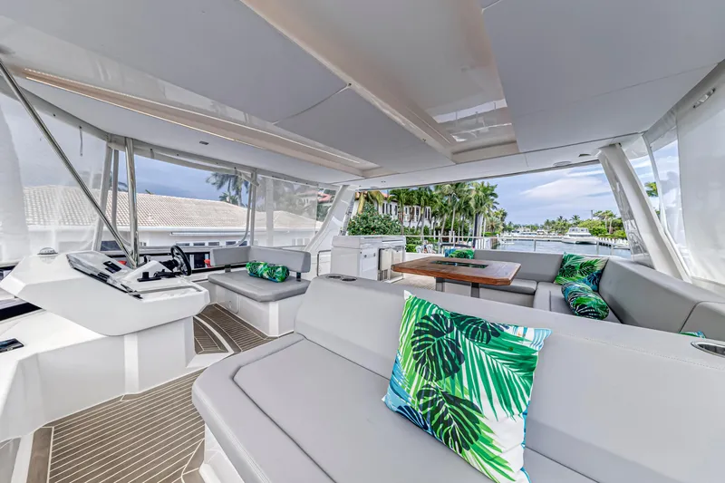Double Feature Yacht Photos Pics Luxurious interior of 2023 Leopard 53 Powercat yacht with tropical-themed cushions.