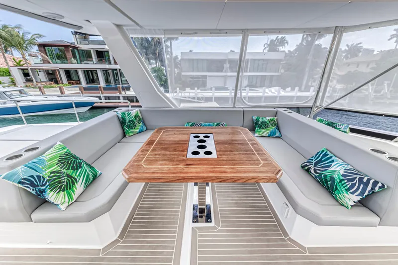 Double Feature Yacht Photos Pics Luxurious 2023 Leopard 53 Powercat yacht interior with elegant seating and tropical-themed cushions.