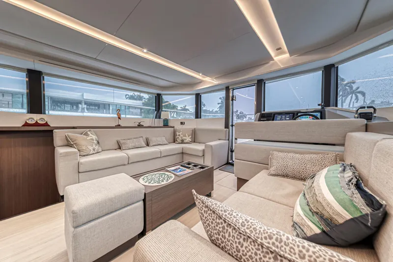 Double Feature Yacht Photos Pics Luxurious interior of 2023 Leopard 53 Powercat yacht with modern seating and panoramic windows.
