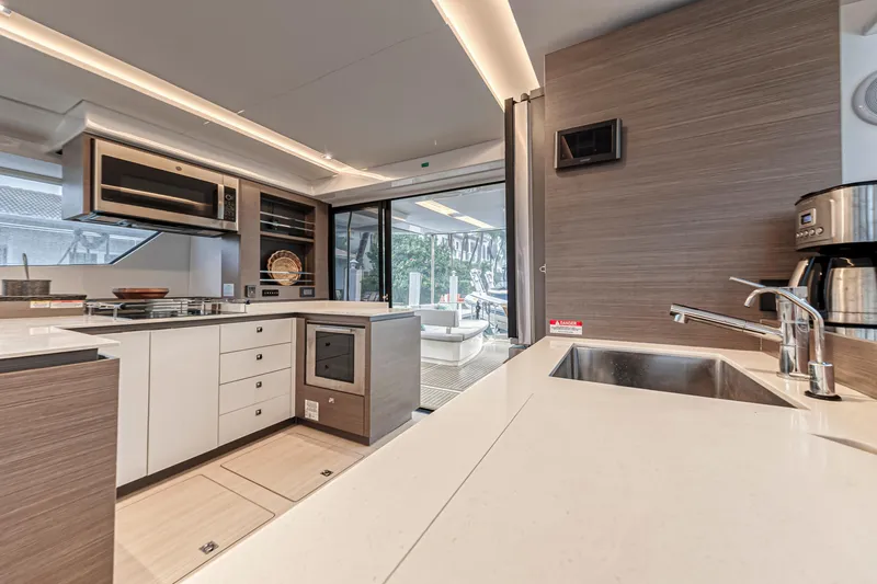 Double Feature Yacht Photos Pics Modern kitchen interior on 2023 Leopard 53 Powercat yacht, featuring sleek design and appliances.