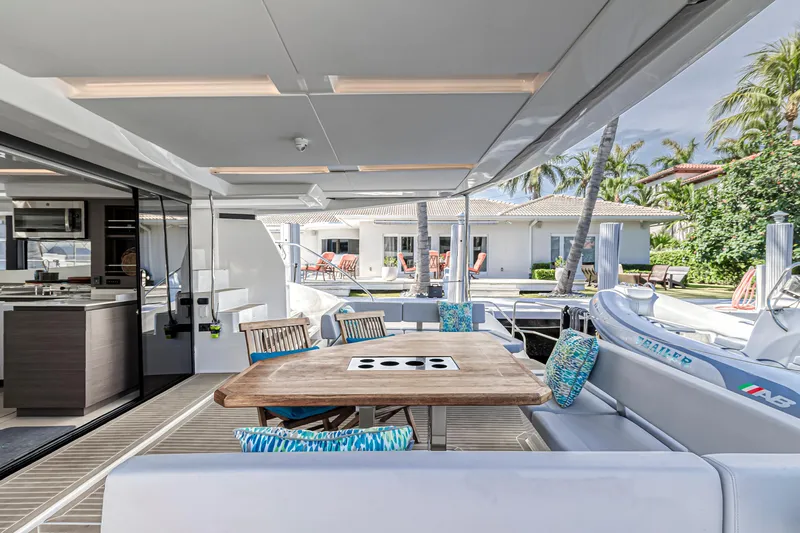 Double Feature Yacht Photos Pics 2023 Leopard 53 Powercat yacht with elegant outdoor seating and dining area.