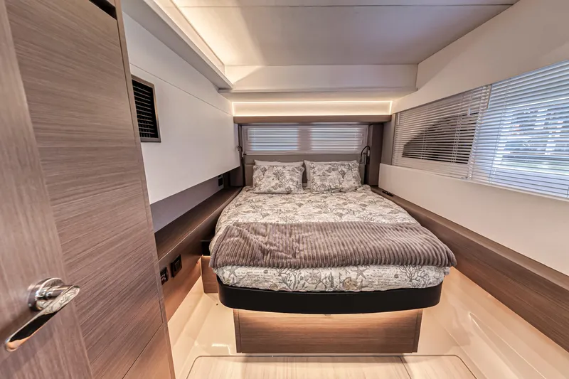 Double Feature Yacht Photos Pics Luxurious bedroom interior of 2023 Leopard 53 Powercat yacht, featuring modern design and cozy bedding.
