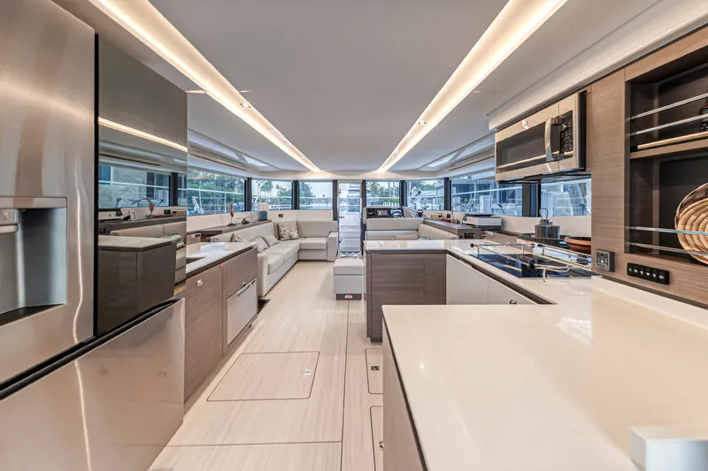 Double Feature Yacht Photos Pics Luxurious interior of 2023 Leopard 53 Powercat yacht with modern kitchen and seating area.