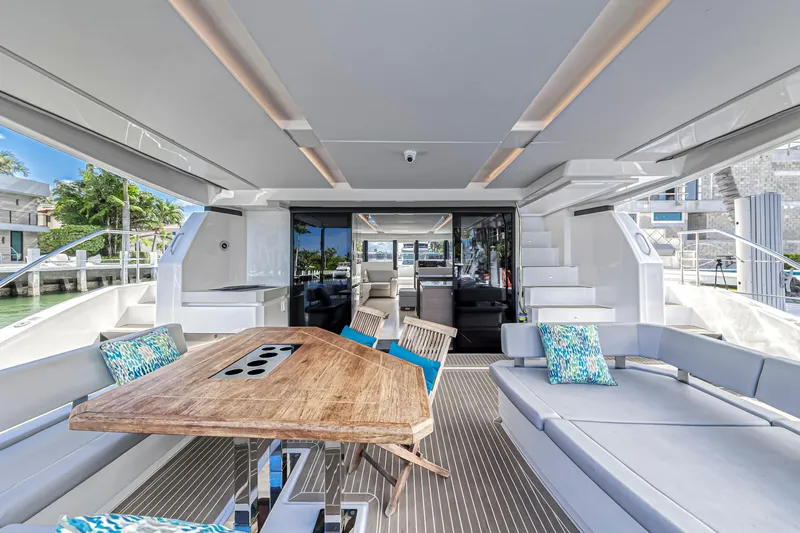 Double Feature Yacht Photos Pics Luxurious interior of 2023 Leopard 53 Powercat yacht with modern seating and wooden table.