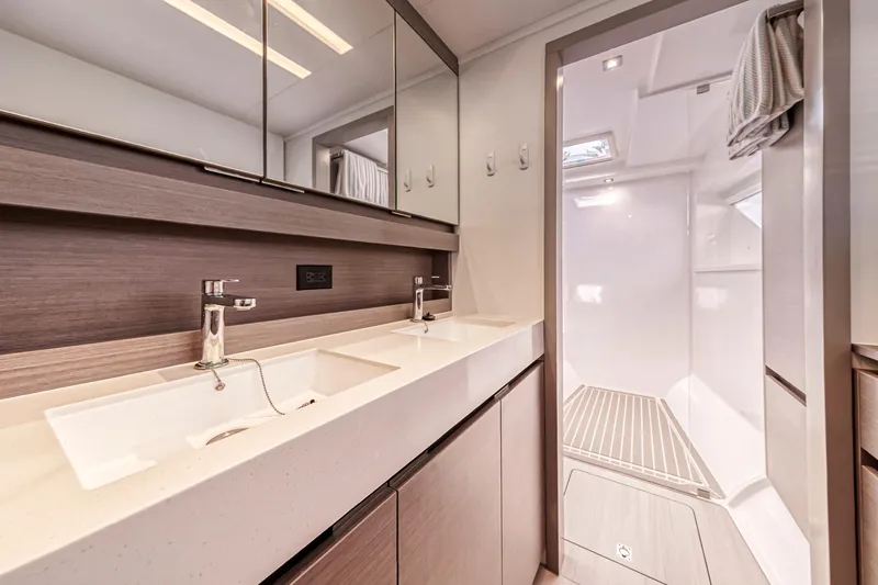 Double Feature Yacht Photos Pics Modern bathroom interior on 2023 Leopard 53 Powercat yacht, featuring dual sinks and spacious shower.