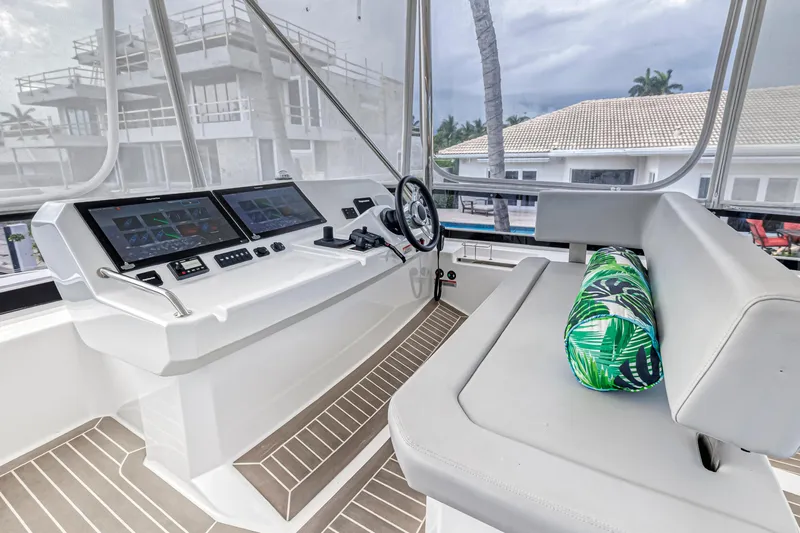 Double Feature Yacht Photos Pics 2023 Leopard 53 Powercat helm with modern controls and tropical cushion.