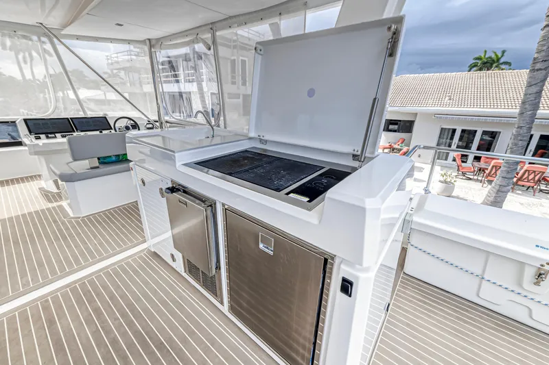 Double Feature Yacht Photos Pics 2023 Leopard 53 Powercat yacht deck with outdoor kitchen and grill.