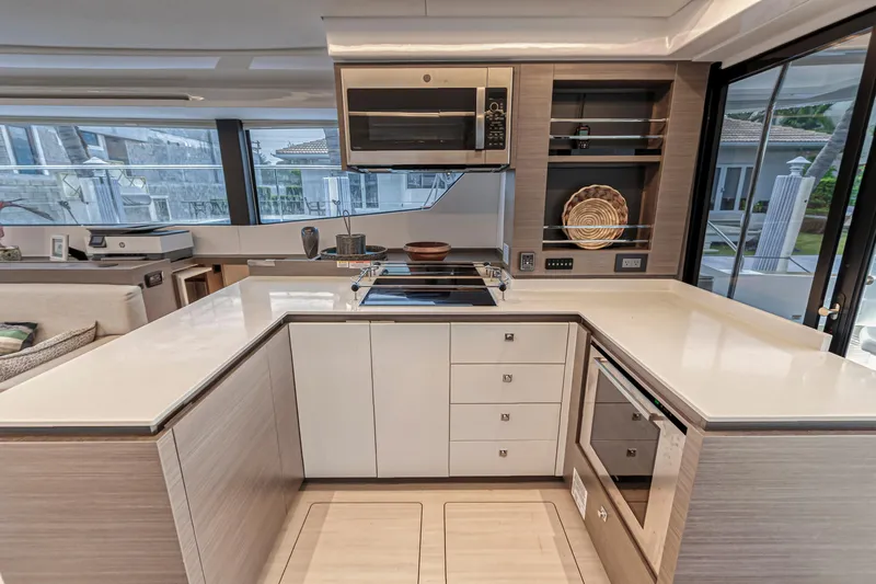 Double Feature Yacht Photos Pics Modern kitchen interior on 2023 Leopard 53 Powercat yacht, featuring sleek countertops and appliances.