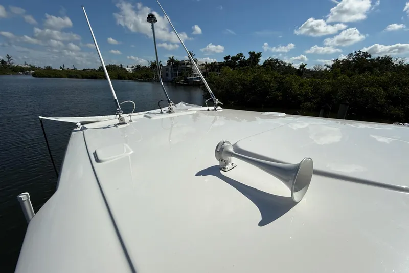  Yacht Photos Pics 2024 Pursuit S 248 Sport boat deck with horn, antennas, and scenic water view.