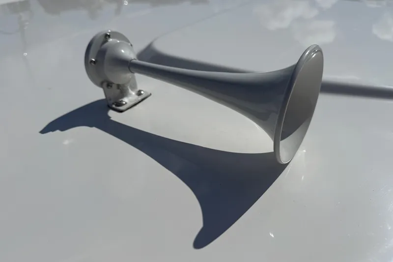  Yacht Photos Pics 2024 Pursuit S 248 Sport boat horn on a sleek white surface.