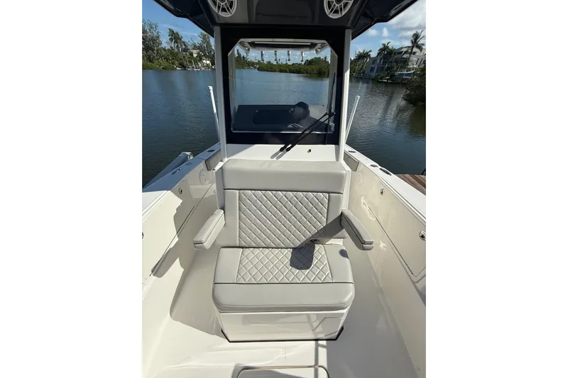  Yacht Photos Pics 2024 Pursuit S 248 Sport boat interior with cushioned seating and water view.