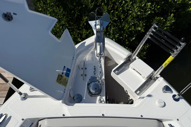  Yacht Photos Pics 2024 Pursuit S 248 Sport boat anchor compartment with open hatch and ladder.