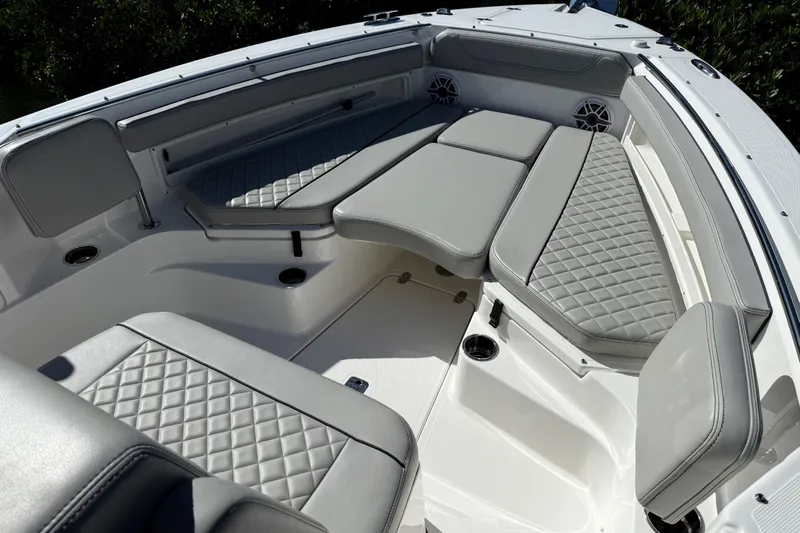  Yacht Photos Pics 2024 Pursuit S 248 Sport boat interior with gray cushioned seating and diamond stitching.