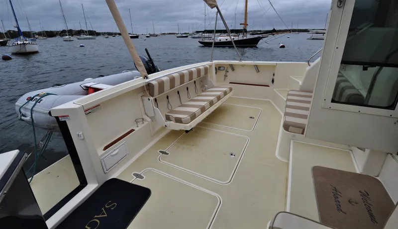 Dawn Treader Yacht Photos Pics 2008 Sabre 42 Hard Top Express boat deck with seating, docked in a marina.