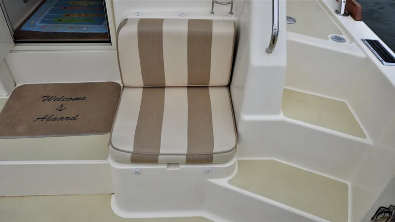 Dawn Treader Yacht Photos Pics Striped seat and welcome mat on 2008 Sabre 42 Hard Top Express yacht.