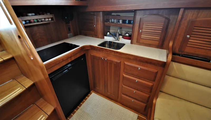 Dawn Treader Yacht Photos Pics 2008 Sabre 42 Hard Top Express yacht interior kitchen with wooden cabinetry and modern appliances.