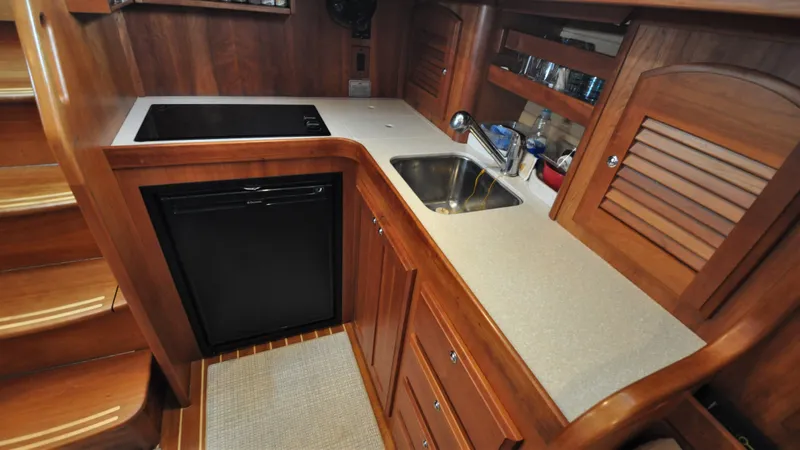 Dawn Treader Yacht Photos Pics 2008 Sabre 42 Hard Top Express yacht kitchen with wood cabinetry and modern appliances.