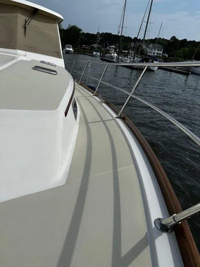 Dawn Treader Yacht Photos Pics 2008 Sabre 42 Hard Top Express yacht deck with railing, docked in a marina.