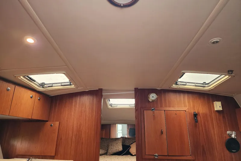  Yacht Photos Pics Interior of 2001 Tiara Yachts 3500 Open, featuring wooden cabinetry and ceiling hatches.