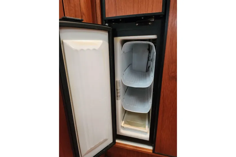  Yacht Photos Pics Open refrigerator in 2001 Tiara Yachts 3500 Open, showcasing interior shelves.