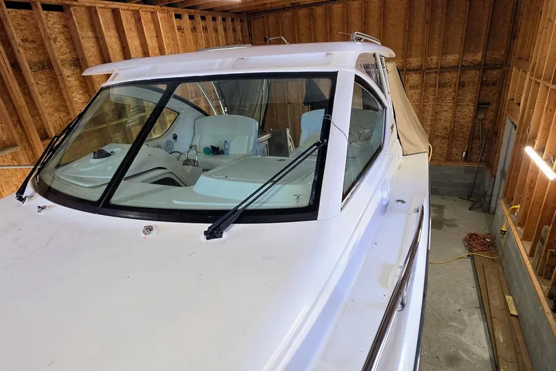  Yacht Photos Pics 2007 Tiara Yachts 3000 Open in a wooden garage, showcasing sleek design and windshield.