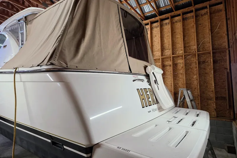  Yacht Photos Pics 2007 Tiara Yachts 3000 Open in storage, featuring a beige canopy and swim platform.