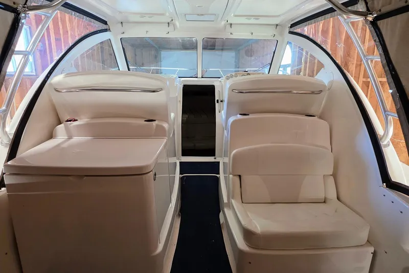  Yacht Photos Pics 2007 Tiara Yachts 3000 Open interior with white seating and helm station.