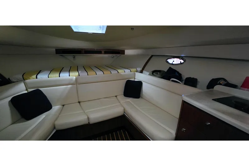  Yacht Photos Pics Interior of 2007 Tiara Yachts 3000 Open with white seating and striped bedding.