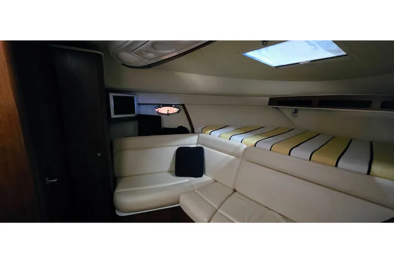  Yacht Photos Pics 2007 Tiara Yachts 3000 Open cabin interior with seating and striped bedding.