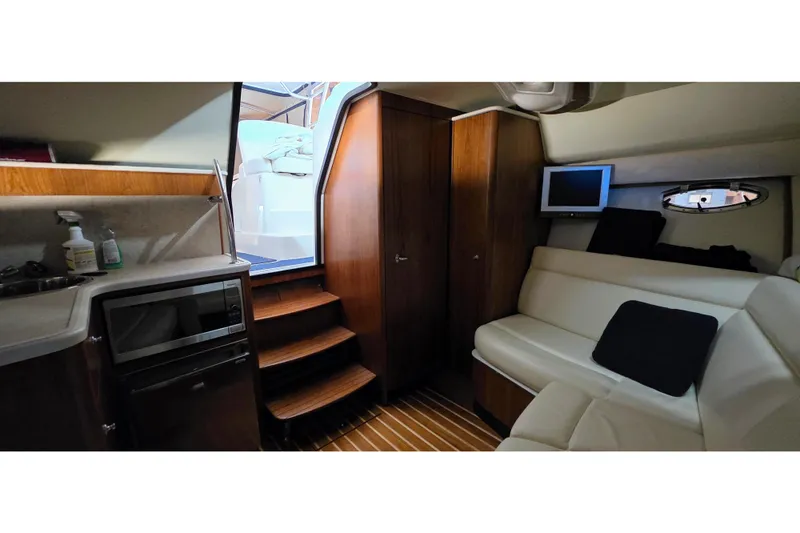  Yacht Photos Pics Interior of 2007 Tiara Yachts 3000 Open, featuring a cozy cabin with seating and kitchenette.