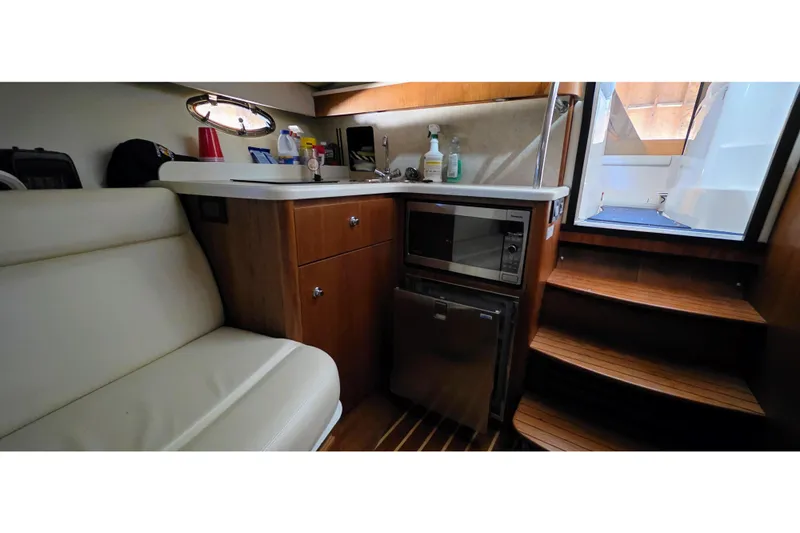  Yacht Photos Pics 2007 Tiara Yachts 3000 Open interior with kitchenette, microwave, and stairs.