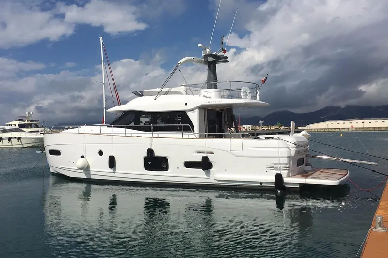 Mizar Yacht Photos Pics 2017 Azimut Magellano 53 yacht docked in a marina under cloudy skies.
