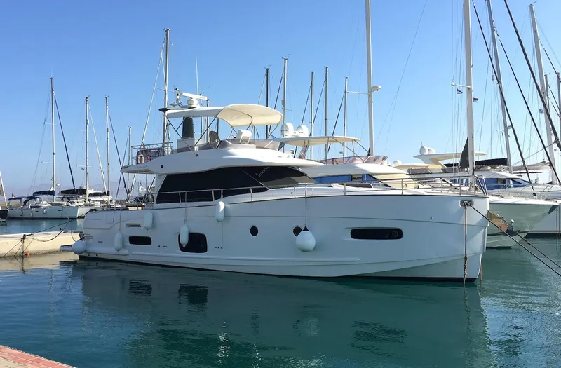 Mizar Yacht Photos Pics 2017 Azimut Magellano 53 yacht docked in a marina, surrounded by sailboats.