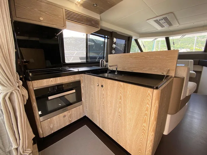 Mizar Yacht Photos Pics Modern kitchen interior of 2017 Azimut Magellano 53 yacht with wood finish and appliances.