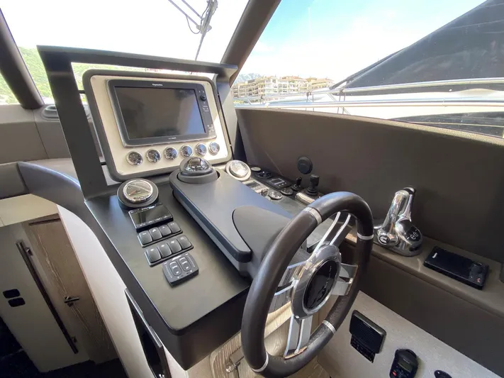 Mizar Yacht Photos Pics Cockpit of 2017 Azimut Magellano 53 yacht with modern navigation controls and steering wheel.