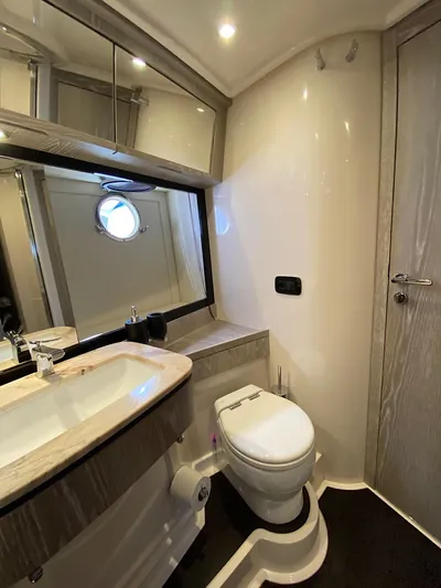 Mizar Yacht Photos Pics Luxurious bathroom in 2017 Azimut Magellano 53 yacht with modern fixtures and porthole window.