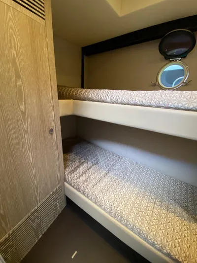 Mizar Yacht Photos Pics Bunk beds in 2017 Azimut Magellano 53 yacht cabin with porthole view.
