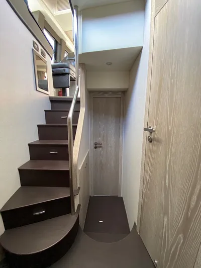 Mizar Yacht Photos Pics Interior staircase of 2017 Azimut Magellano 53 yacht, featuring modern design and wood finishes.