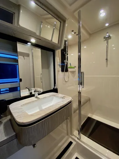 Mizar Yacht Photos Pics Luxurious bathroom in 2017 Azimut Magellano 53 yacht with modern fixtures and shower.