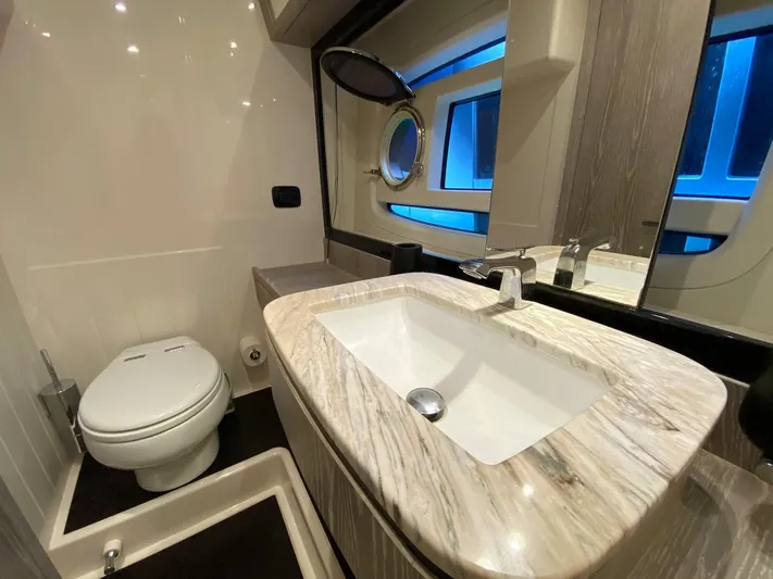 Mizar Yacht Photos Pics Luxurious bathroom in 2017 Azimut Magellano 53 yacht with modern fixtures and elegant design.