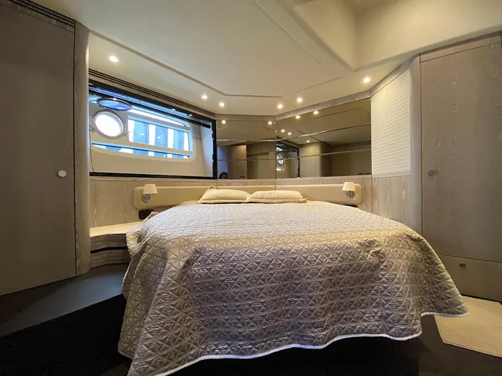 Mizar Yacht Photos Pics Luxurious bedroom interior of 2017 Azimut Magellano 53 yacht with elegant bedding and ambient lighting.