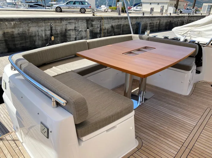 Mizar Yacht Photos Pics Luxurious seating area on 2017 Azimut Magellano 53 yacht with wooden table.