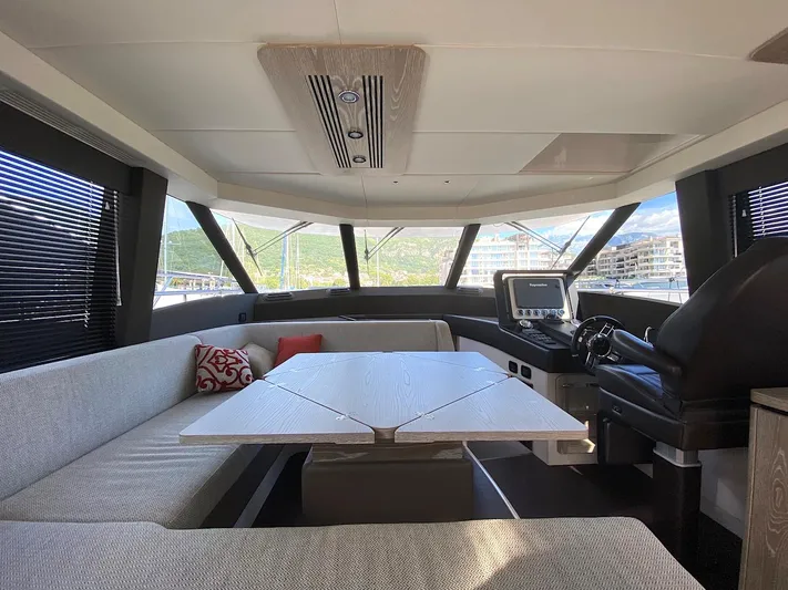 Mizar Yacht Photos Pics Luxurious interior of 2017 Azimut Magellano 53 yacht with modern seating and helm.