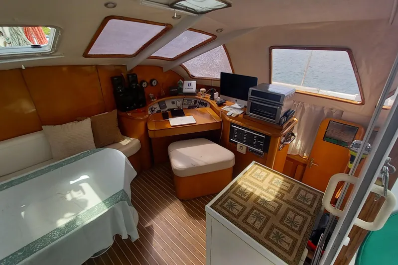 Yellowrock Yacht Photos Pics Interior of 1996 Alliaura Privilege 37 catamaran with navigation station and seating area.